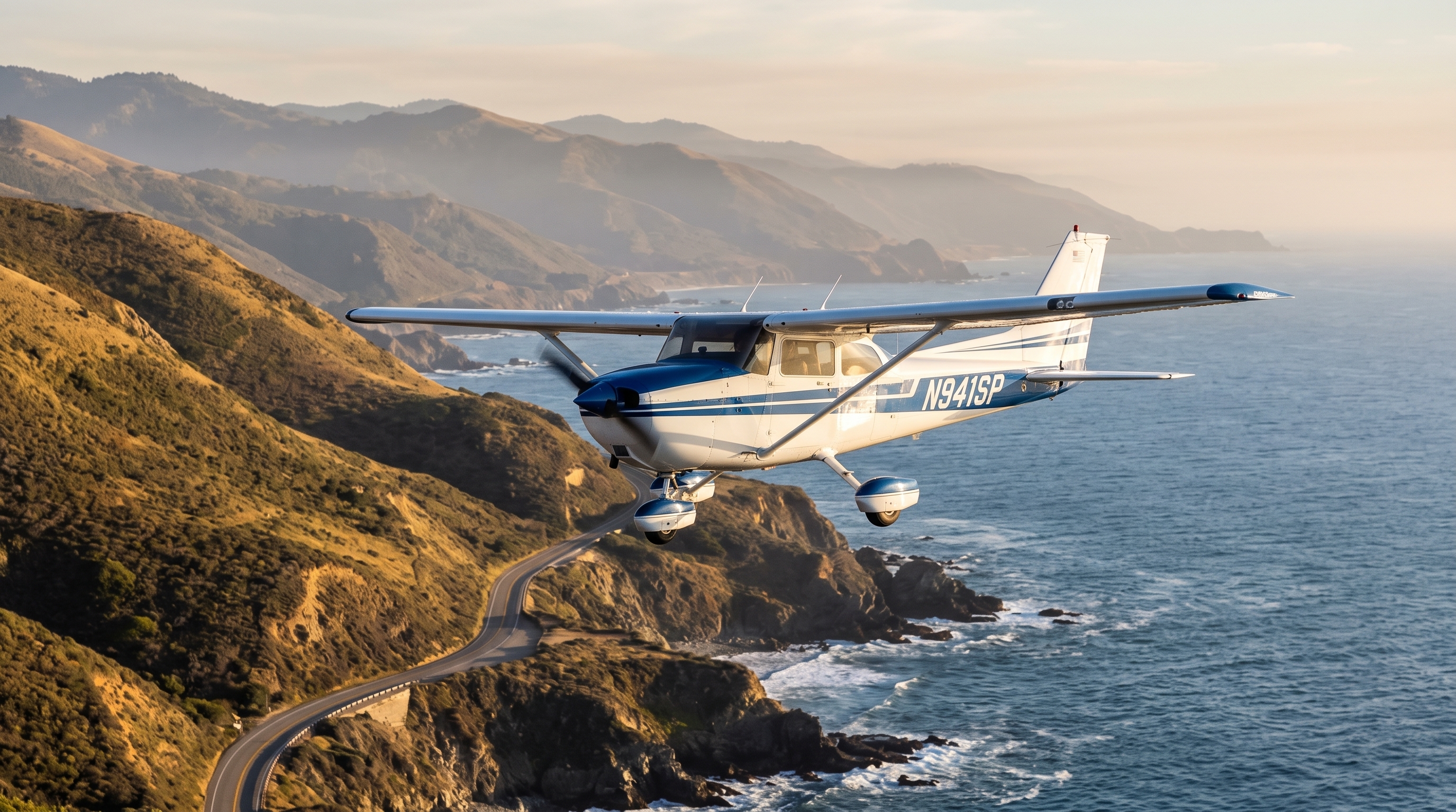 Cessna N941SP flying along the California coast at golden hour